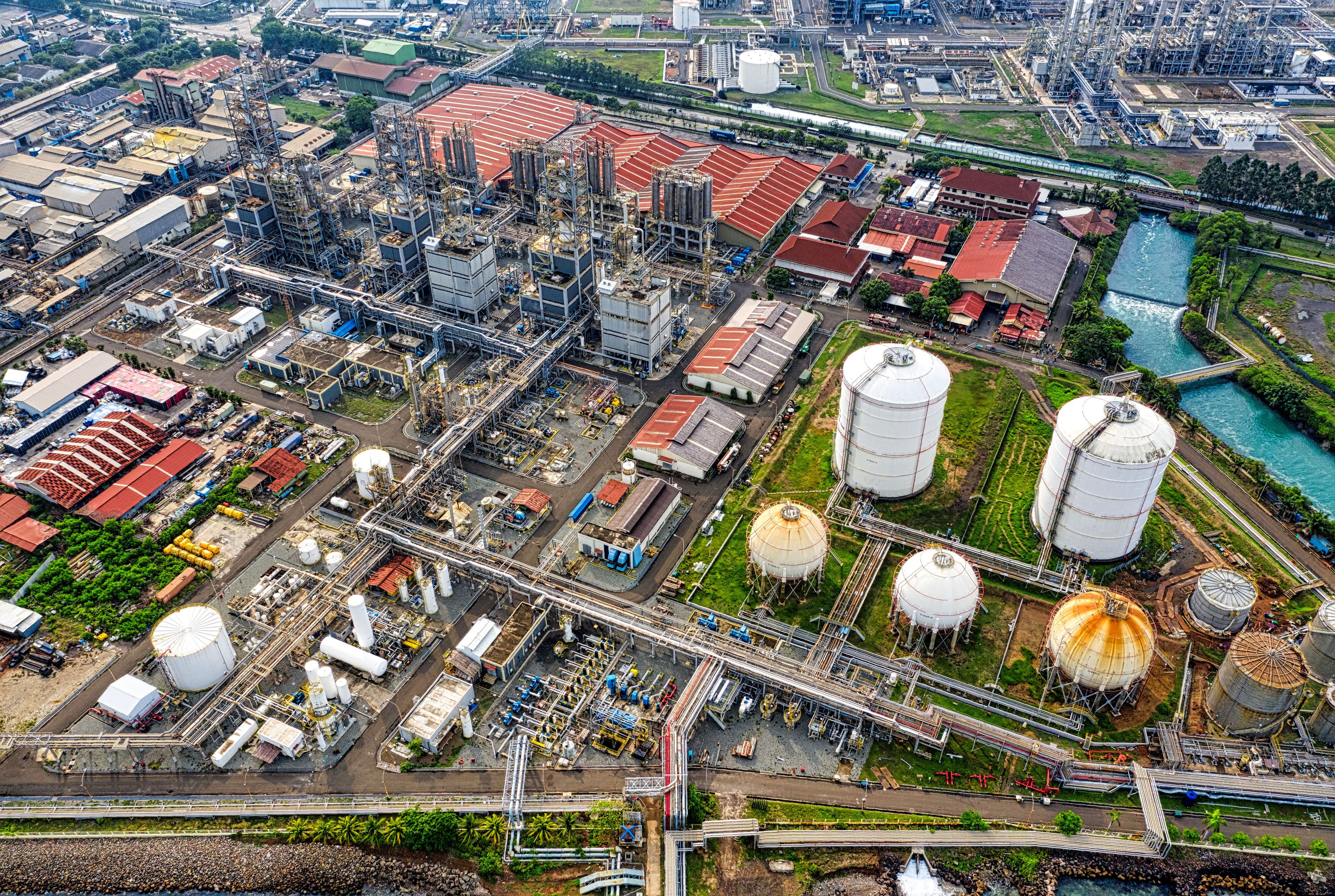 Aerial view of industrial complex with storage tanks and piping