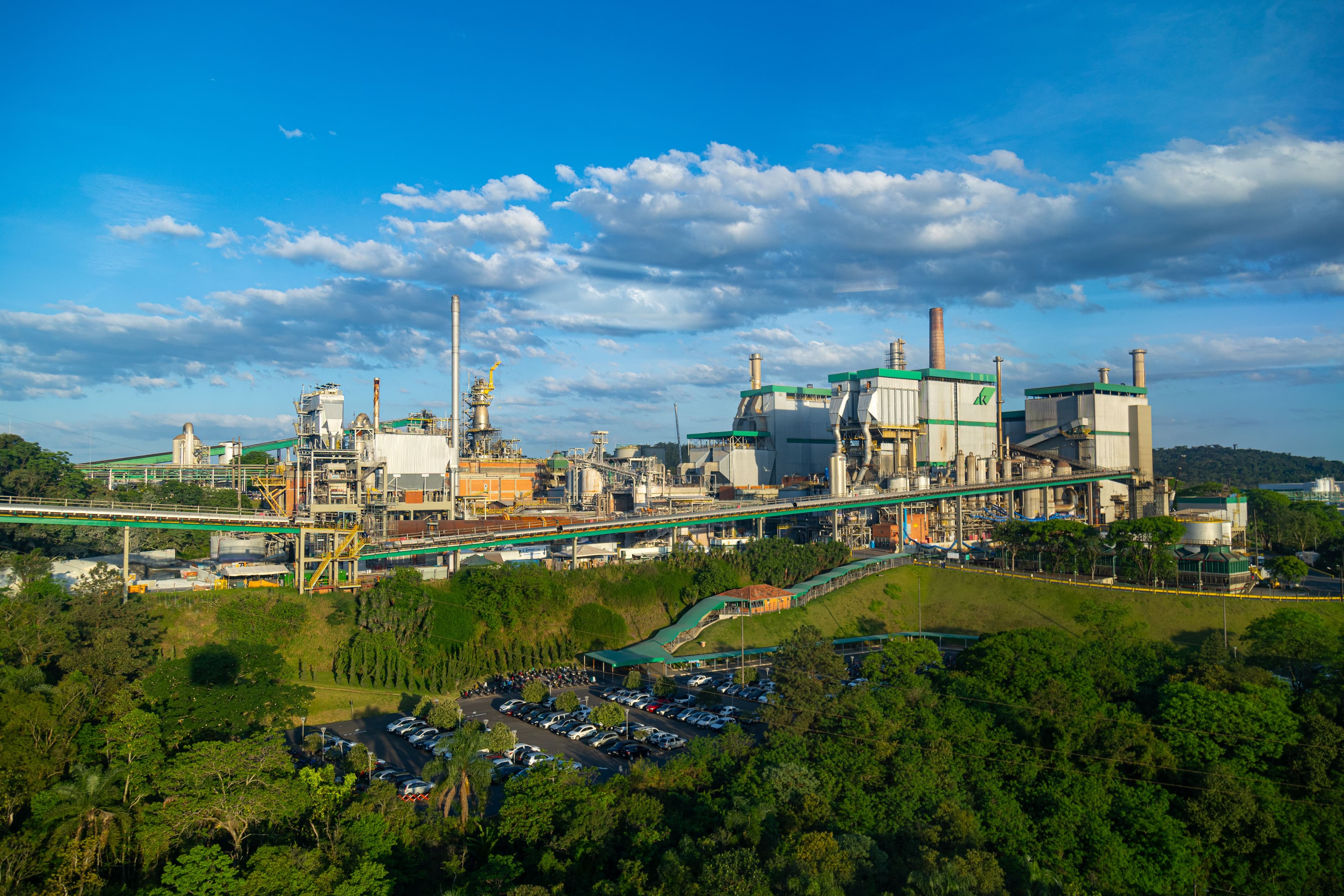 Aerial view of cement plant with conveyors and green structures